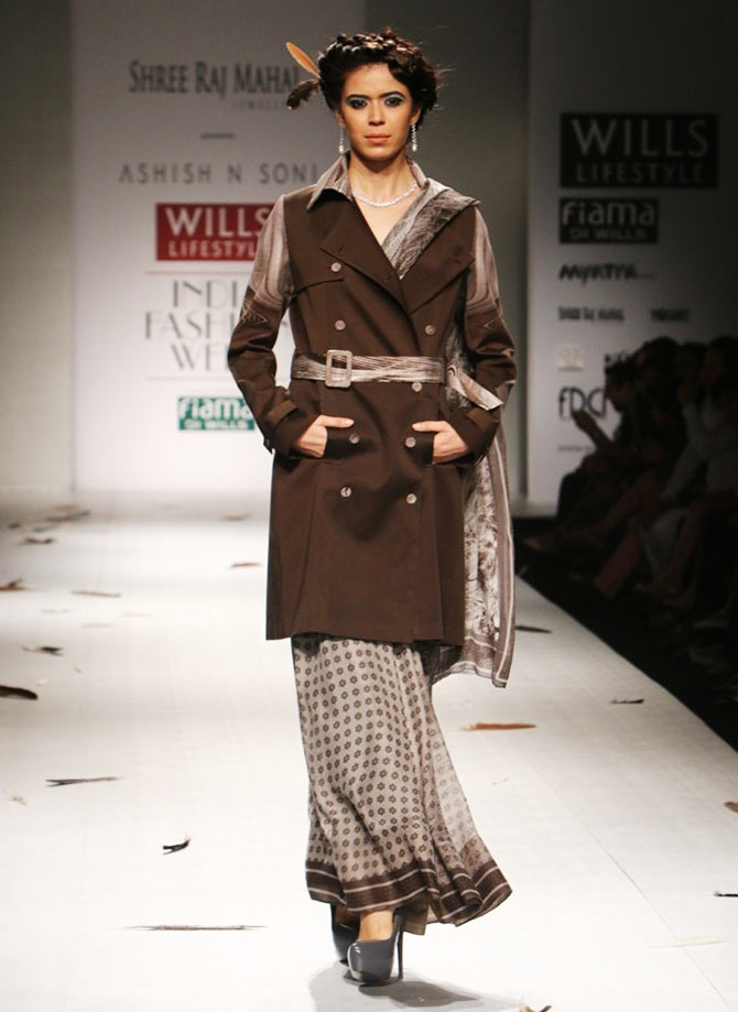Trench coat teamed with Sari. 